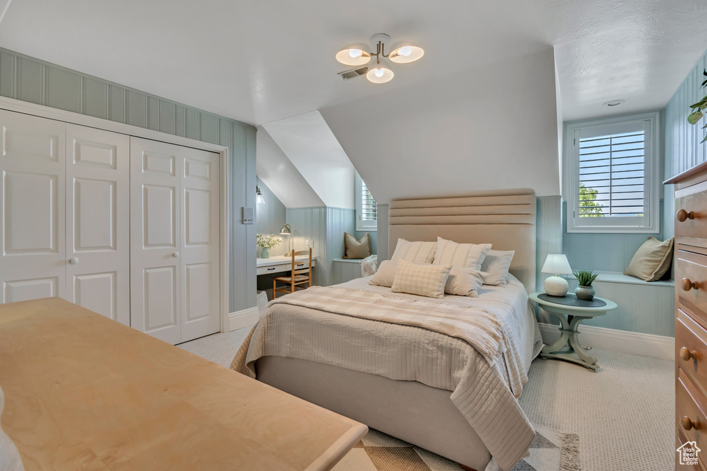 Bedroom featuring multiple windows, carpet floors, and a closet