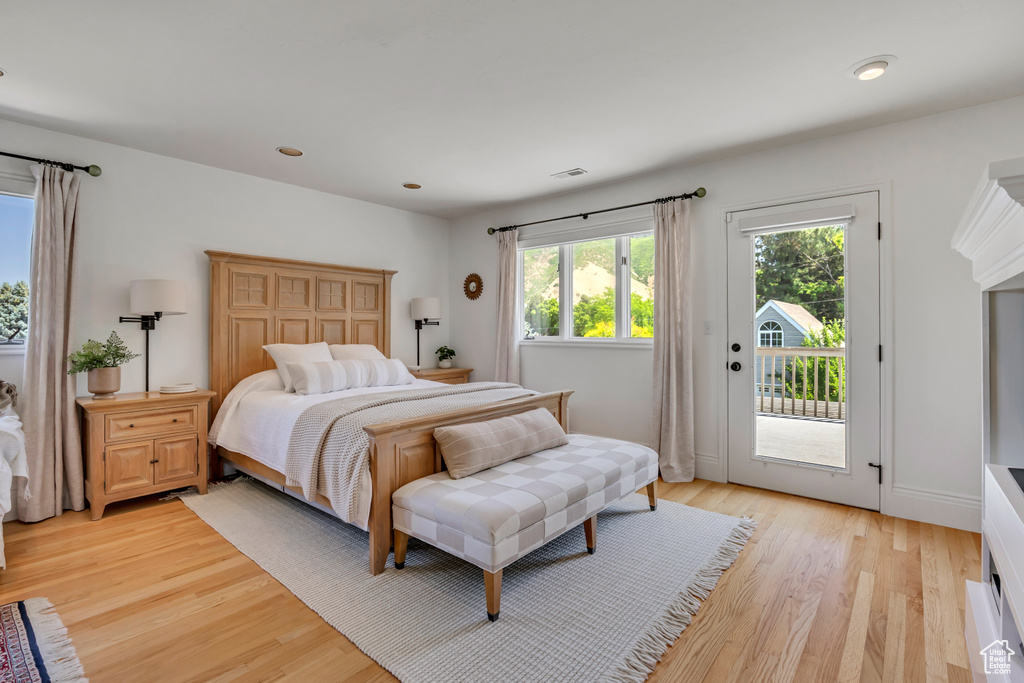 Bedroom with access to outside, light wood finished floors, and recessed lighting