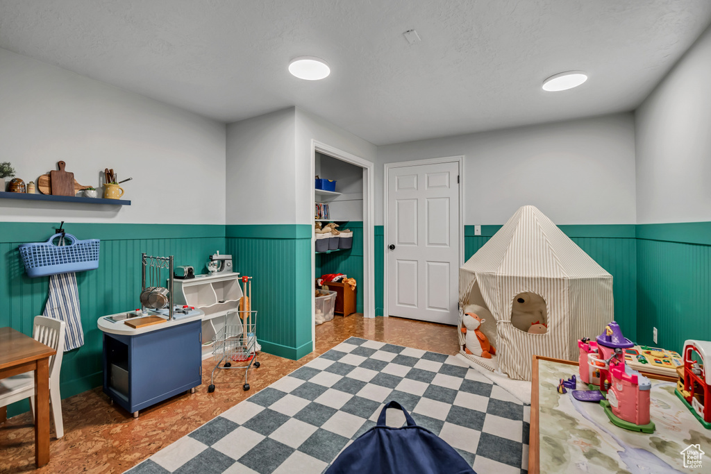 Recreation room featuring a wainscoted wall