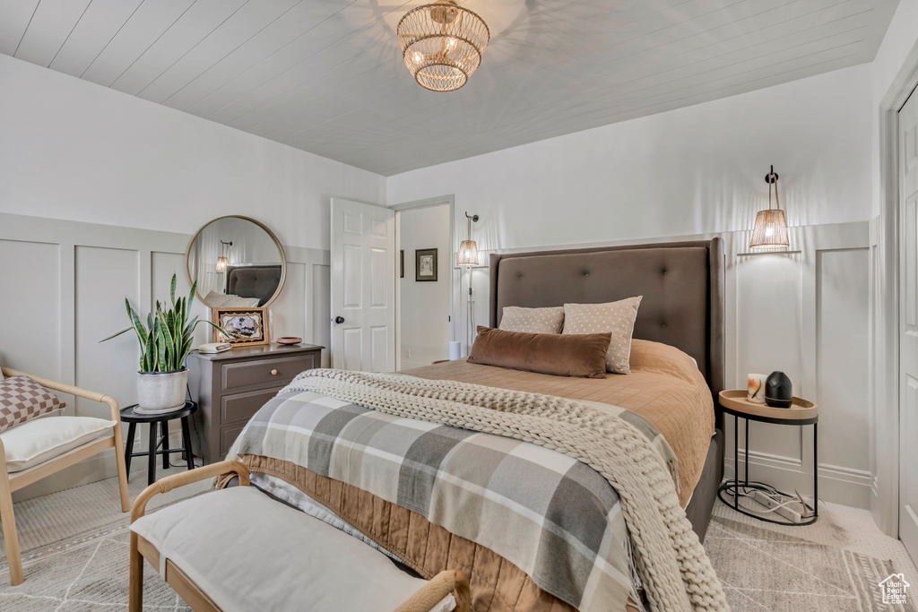 Carpeted bedroom with a decorative wall
