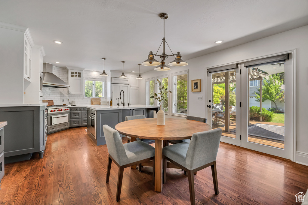 Dining area featuring recessed lighting and dark wood-type flooring