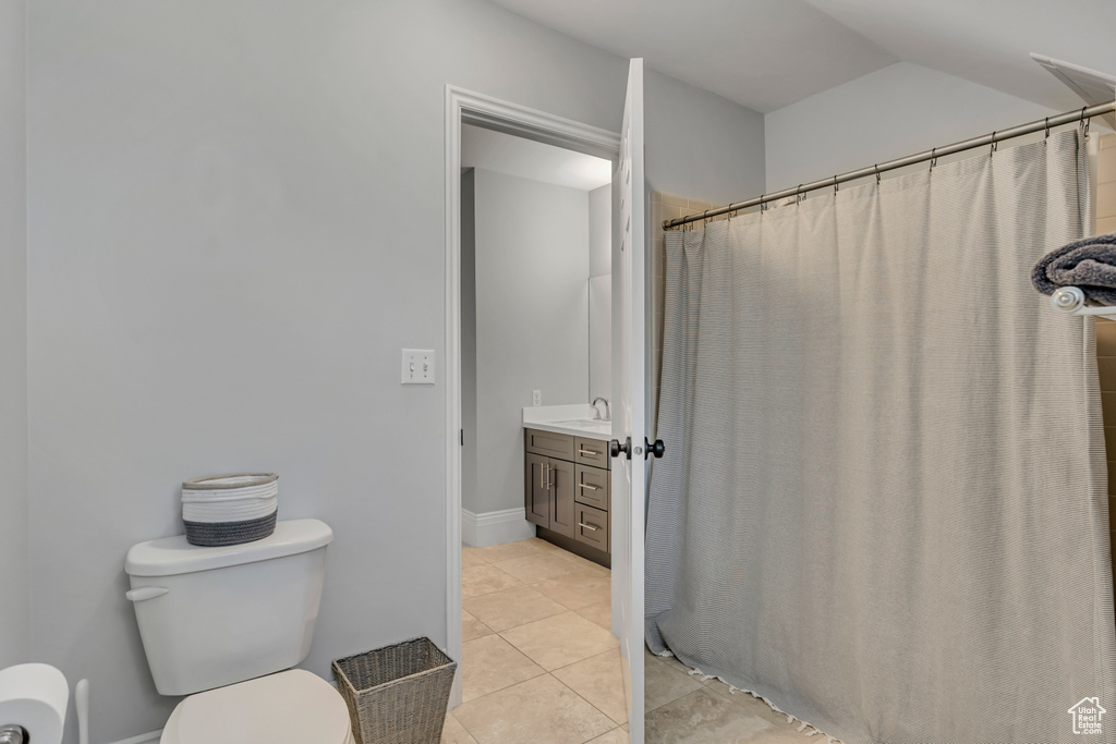 Bathroom with vanity, curtained shower, and tile patterned floors