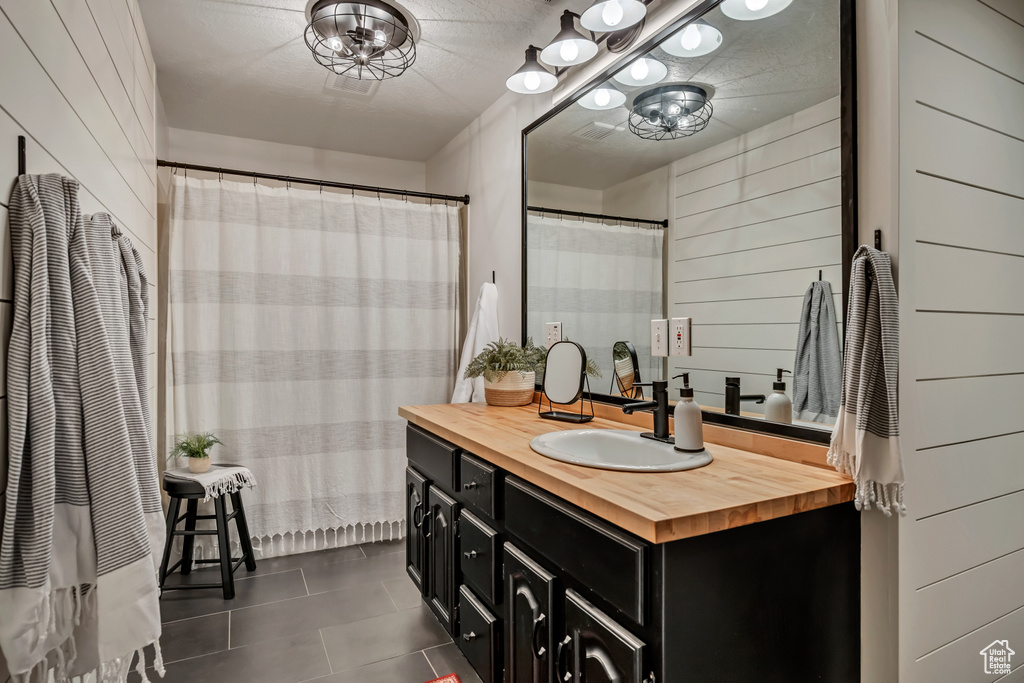 Bathroom featuring tile patterned flooring and vanity