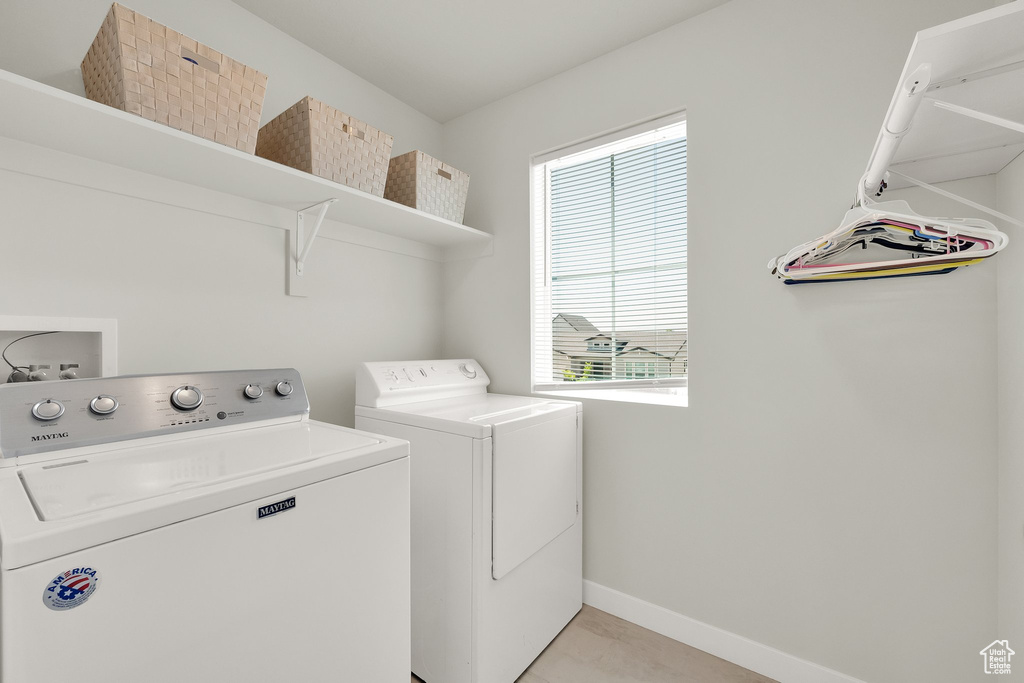 Washroom featuring separate washer and dryer and baseboards