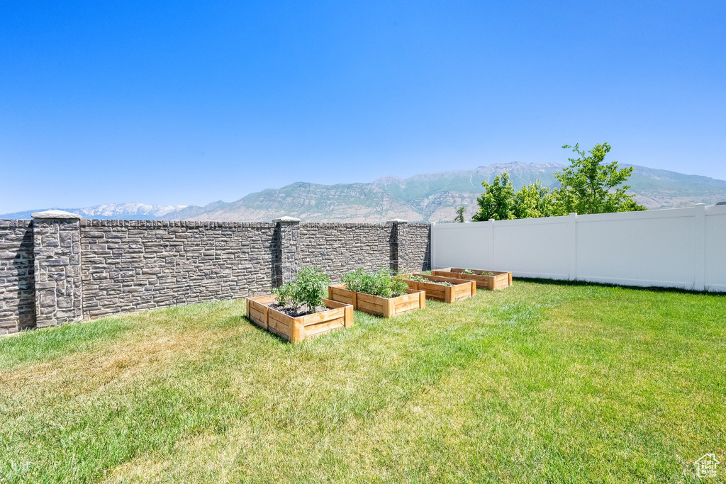 View of yard featuring a garden and a mountain view