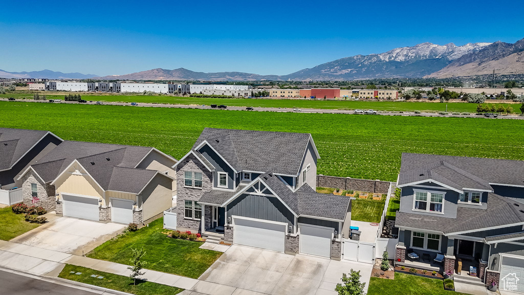 Aerial view of property and surrounding area featuring mountains