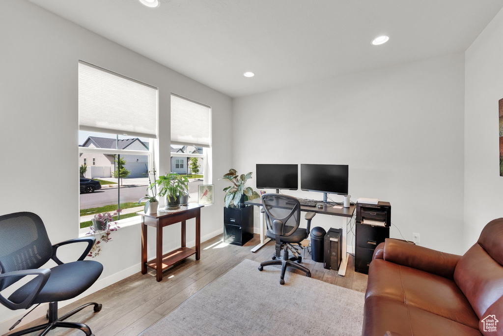 Home office with wood finished floors and recessed lighting