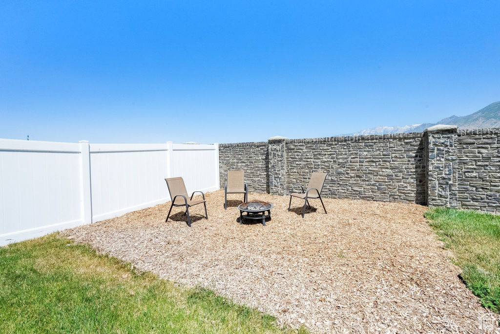 View of yard featuring an outdoor fire pit and a mountain view