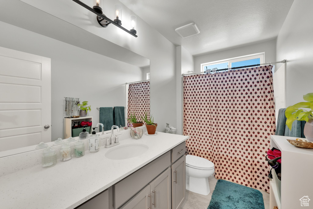 Bathroom with vanity and curtained shower