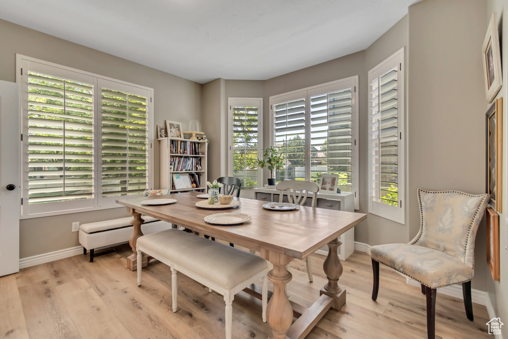 Dining room with plenty of natural light and light wood-style flooring
