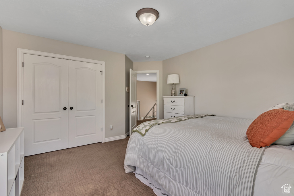 Bedroom featuring carpet flooring and a closet