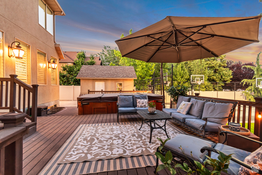 Deck featuring a hot tub and an outdoor living space
