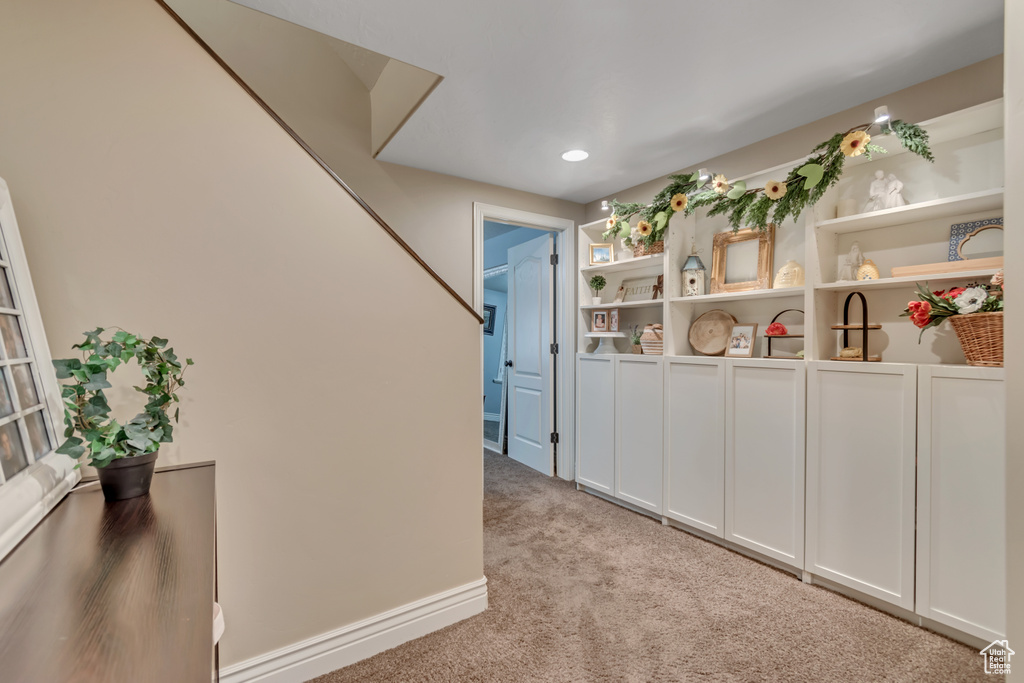 Corridor featuring light colored carpet and recessed lighting