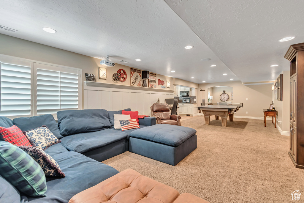 Living room with light colored carpet, recessed lighting, a textured ceiling, and billiards