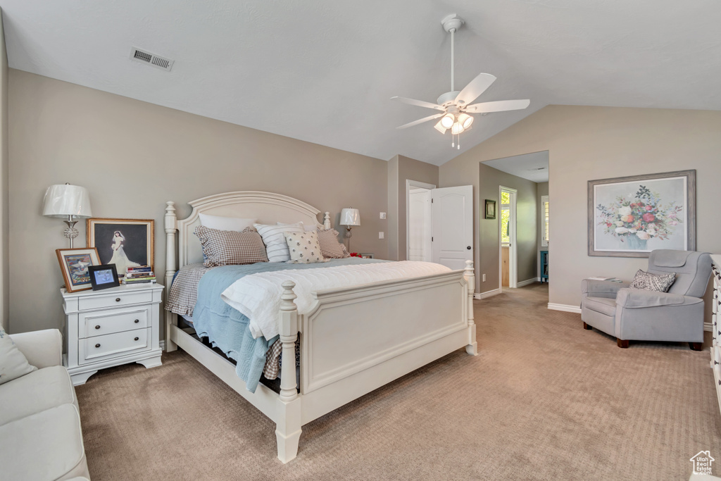 Bedroom featuring light carpet, vaulted ceiling, and ceiling fan