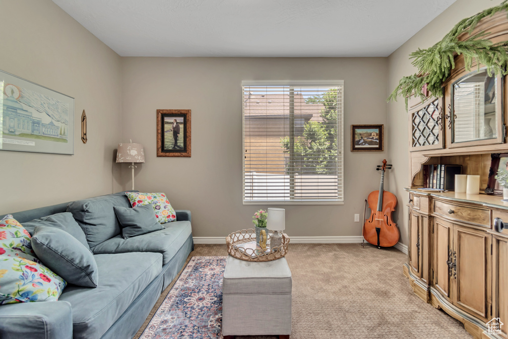 Living room featuring light colored carpet and baseboards