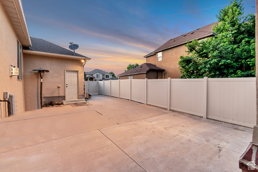 Fenced backyard with a patio