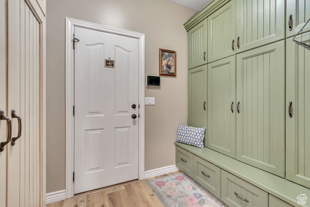 Mudroom with baseboards and light wood-type flooring