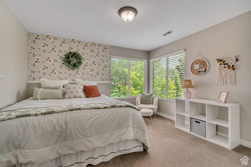 Carpeted bedroom featuring baseboards