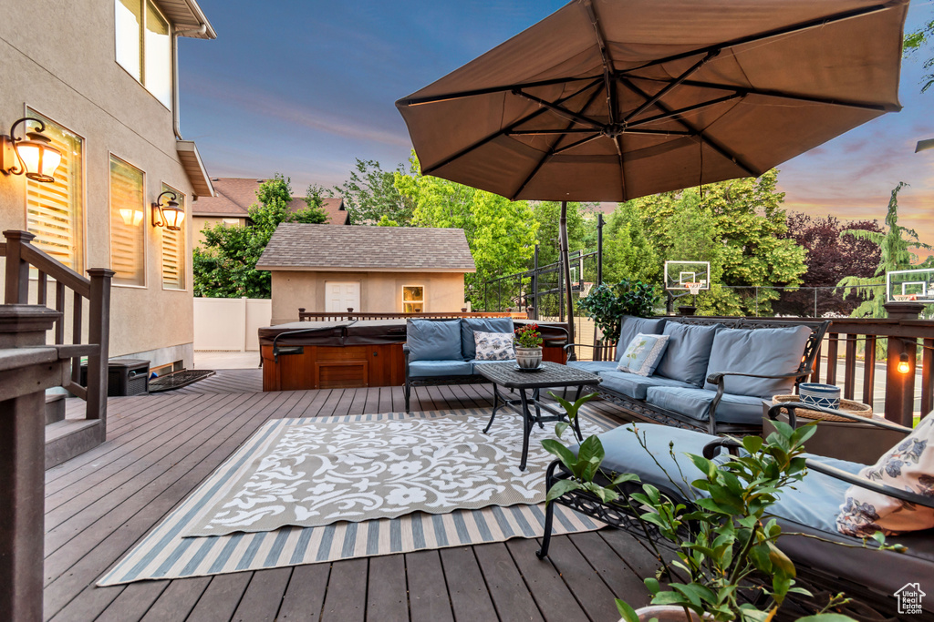 Wooden deck featuring a hot tub and outdoor lounge area