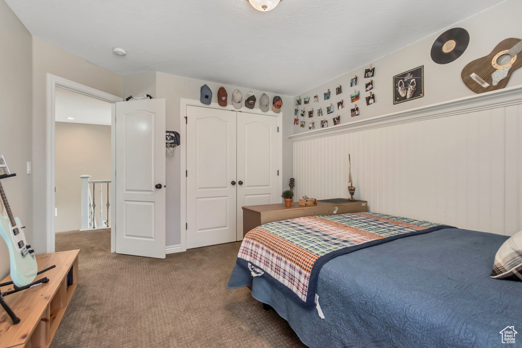 Carpeted bedroom with a closet