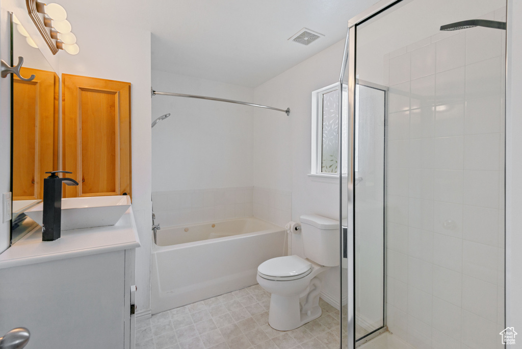 Full bath featuring a tile shower, vanity, and a bath