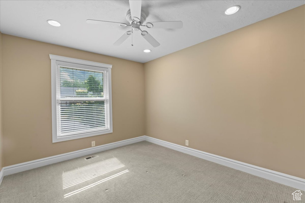 Carpeted spare room with recessed lighting and a ceiling fan