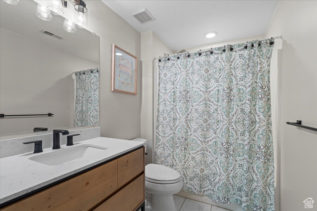 Full bath with vanity, tile patterned floors, and a shower with shower curtain