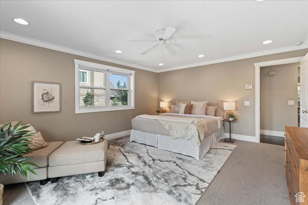 Carpeted bedroom featuring recessed lighting, ornamental molding, and a ceiling fan