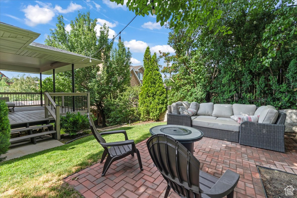 View of patio / terrace featuring an outdoor living space with a fire pit and a wooden deck