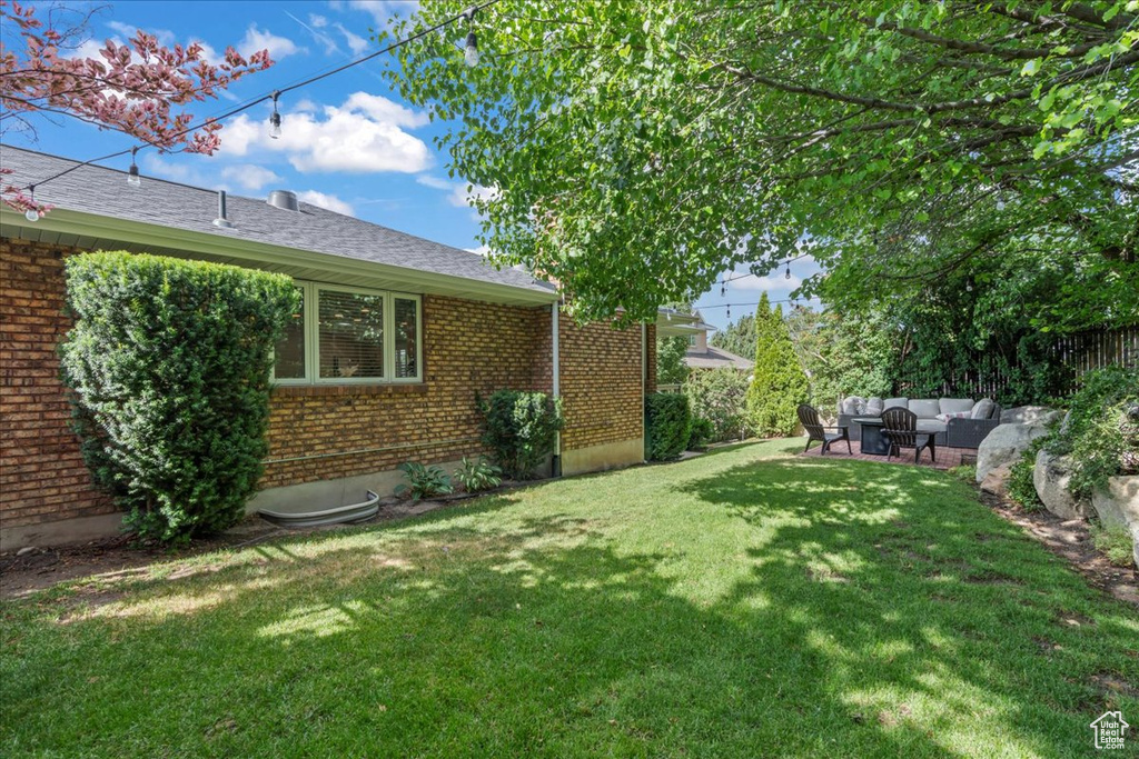 View of green lawn featuring an outdoor living space