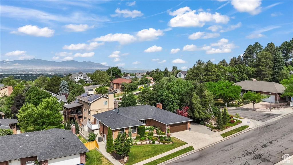 Aerial view of residential area featuring mountains