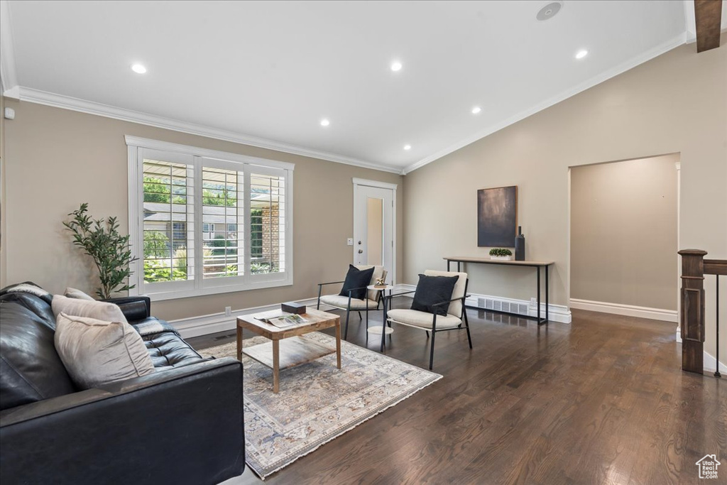 Living room featuring dark wood-type flooring, lofted ceiling, recessed lighting, and crown molding
