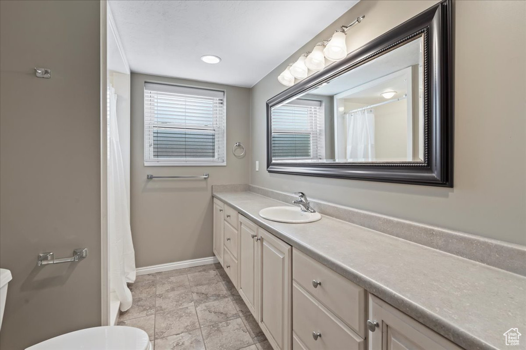 Full bathroom with vanity and toilet