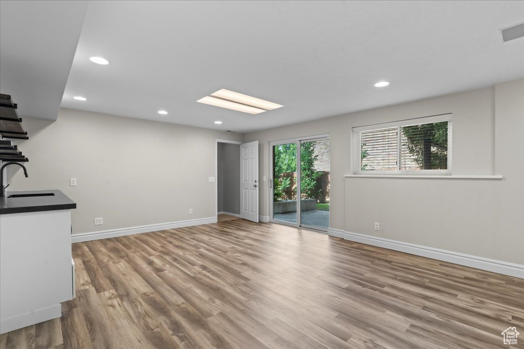 Unfurnished living room featuring wood finished floors and recessed lighting