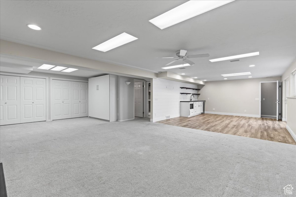 Unfurnished living room featuring carpet floors, a ceiling fan, and recessed lighting