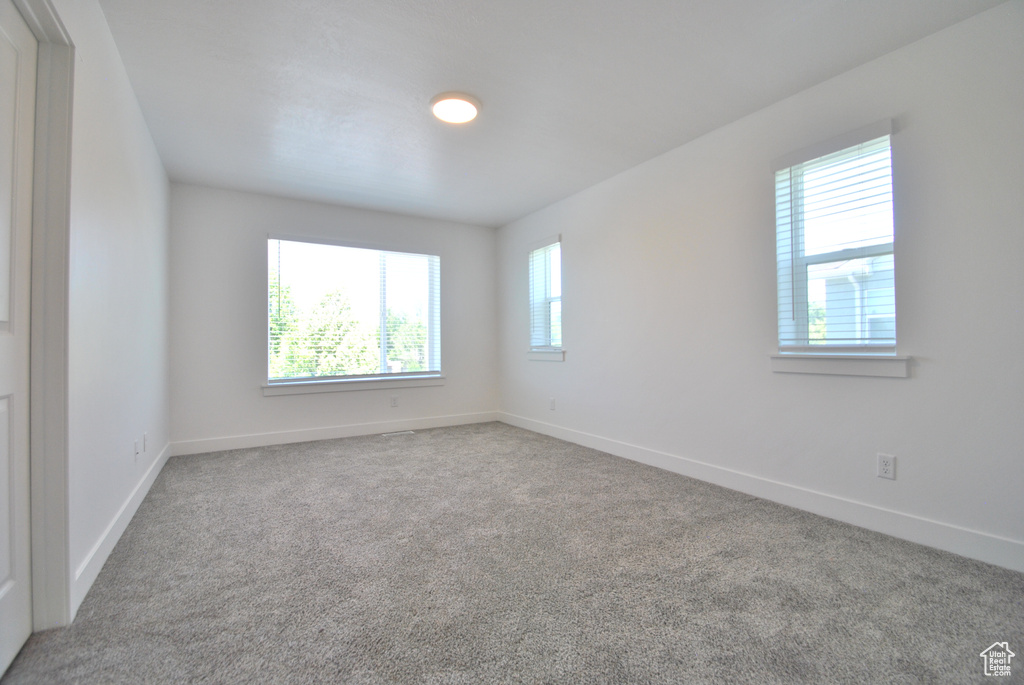 Empty room featuring carpet floors and baseboards