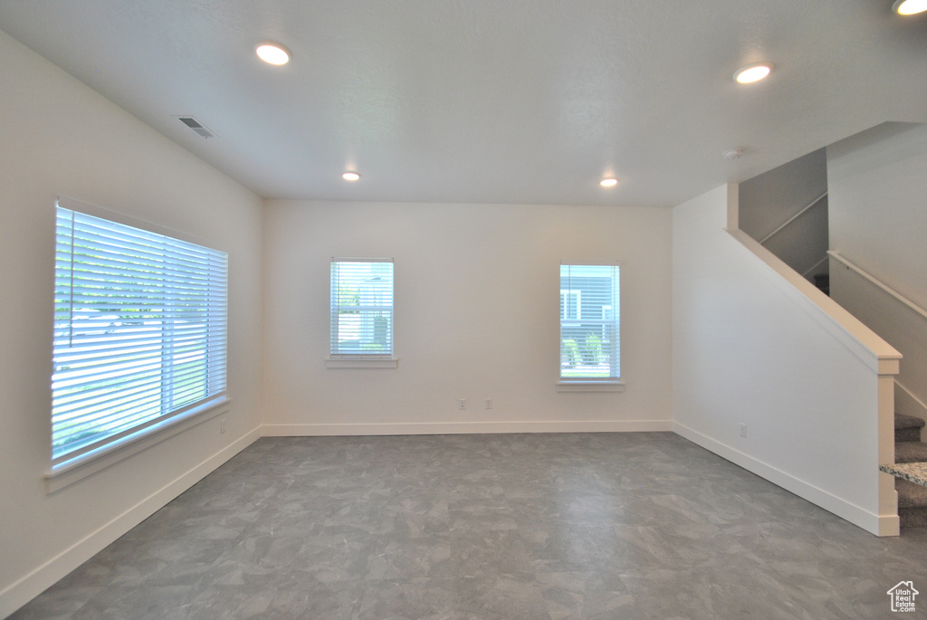 Unfurnished room with recessed lighting and baseboards