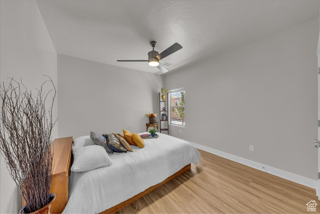 Bedroom featuring light wood-style floors and a ceiling fan