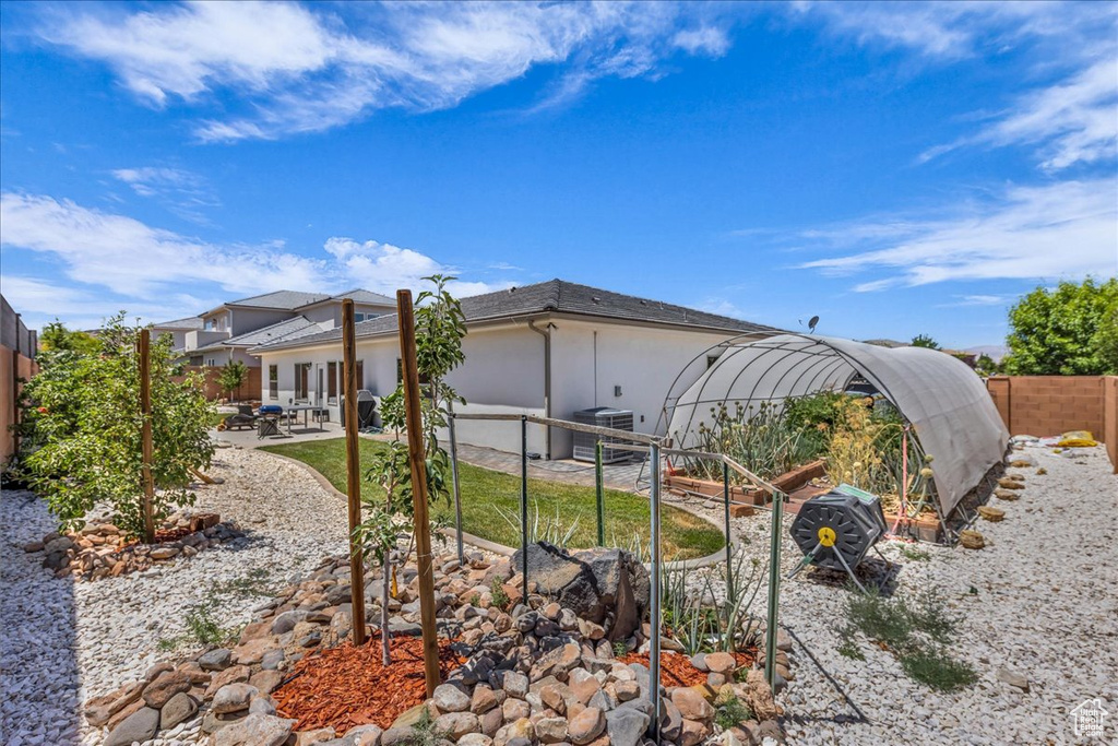 Rear view of property with a patio, a fenced backyard, and stucco siding