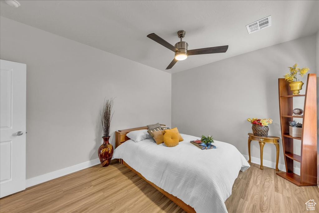 Bedroom with light wood-style flooring and a ceiling fan