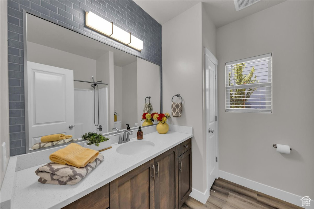 Full bathroom featuring vanity and wood finished floors