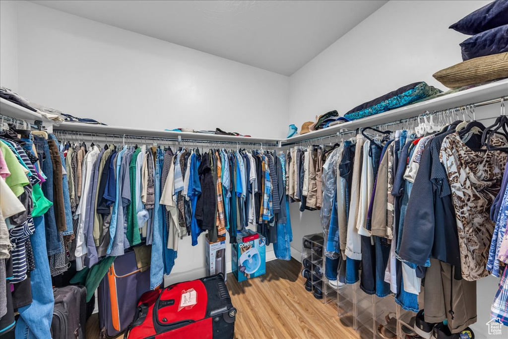 Walk in closet with wood finished floors