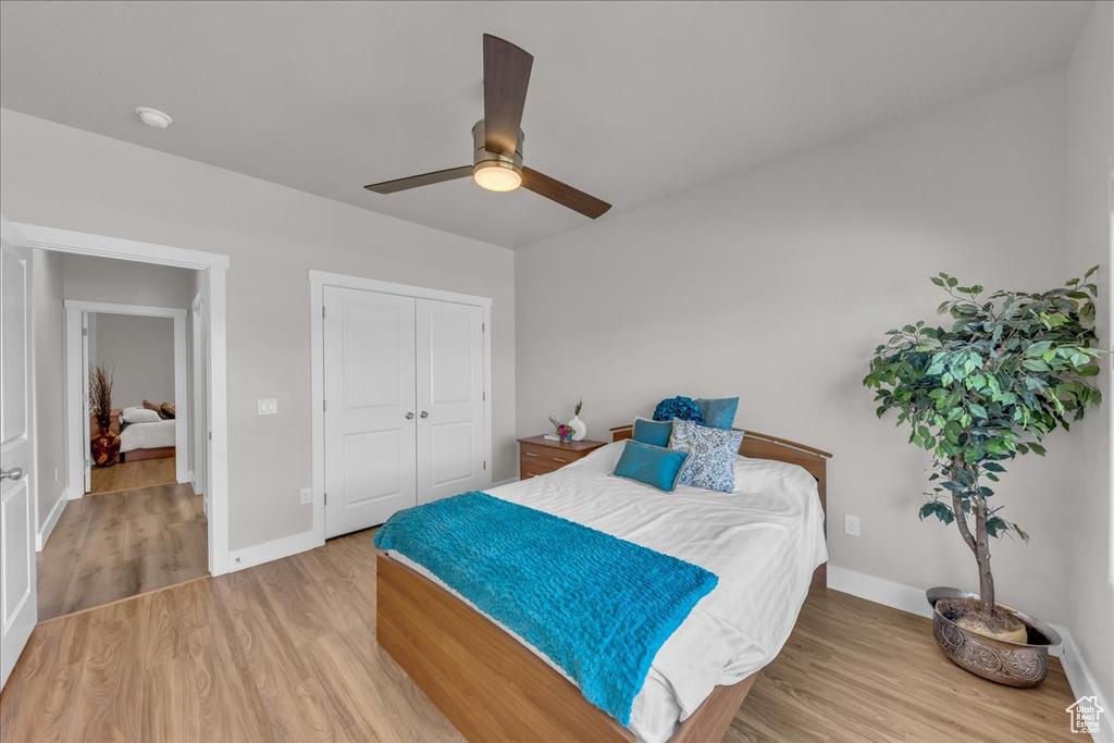 Bedroom featuring wood finished floors, a closet, and ceiling fan