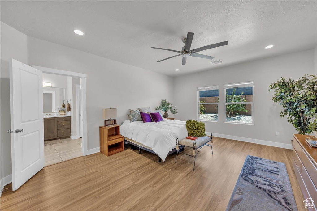 Bedroom featuring light wood-type flooring, recessed lighting, connected bathroom, and a ceiling fan