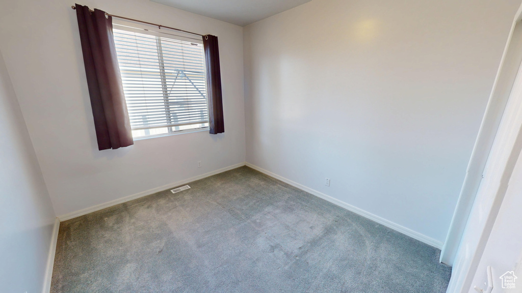 Unfurnished room featuring carpet floors and baseboards