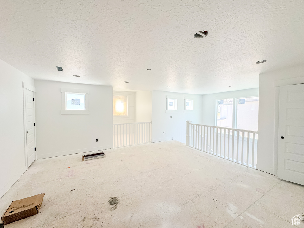 Spare room with healthy amount of natural light and a textured ceiling