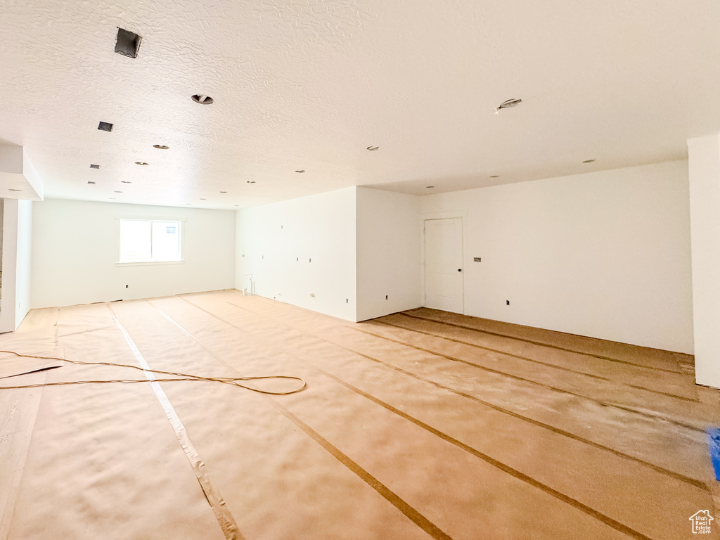 Unfurnished room with a textured ceiling