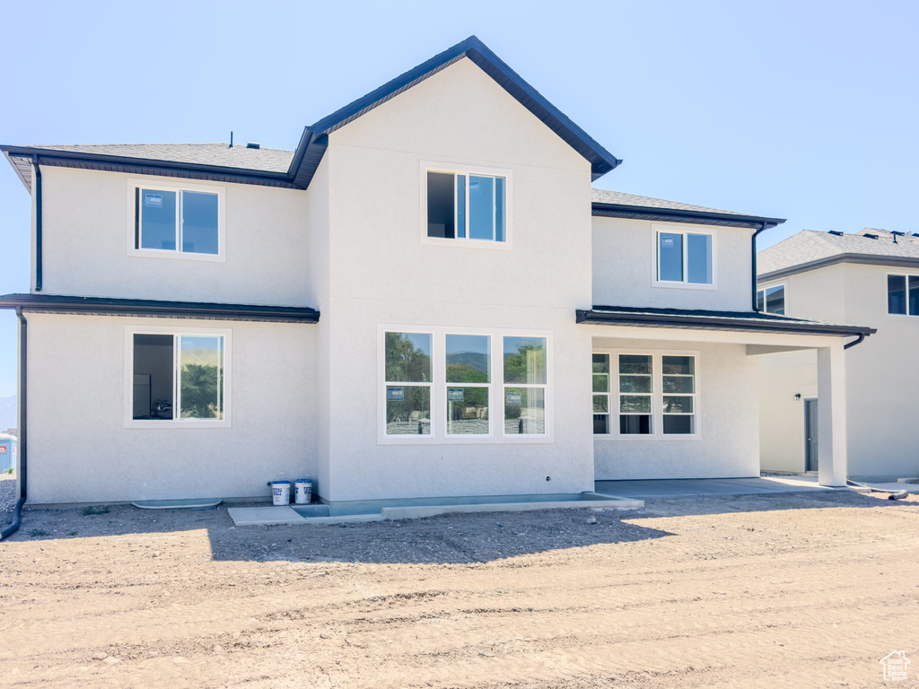 Rear view of property featuring stucco siding and a patio