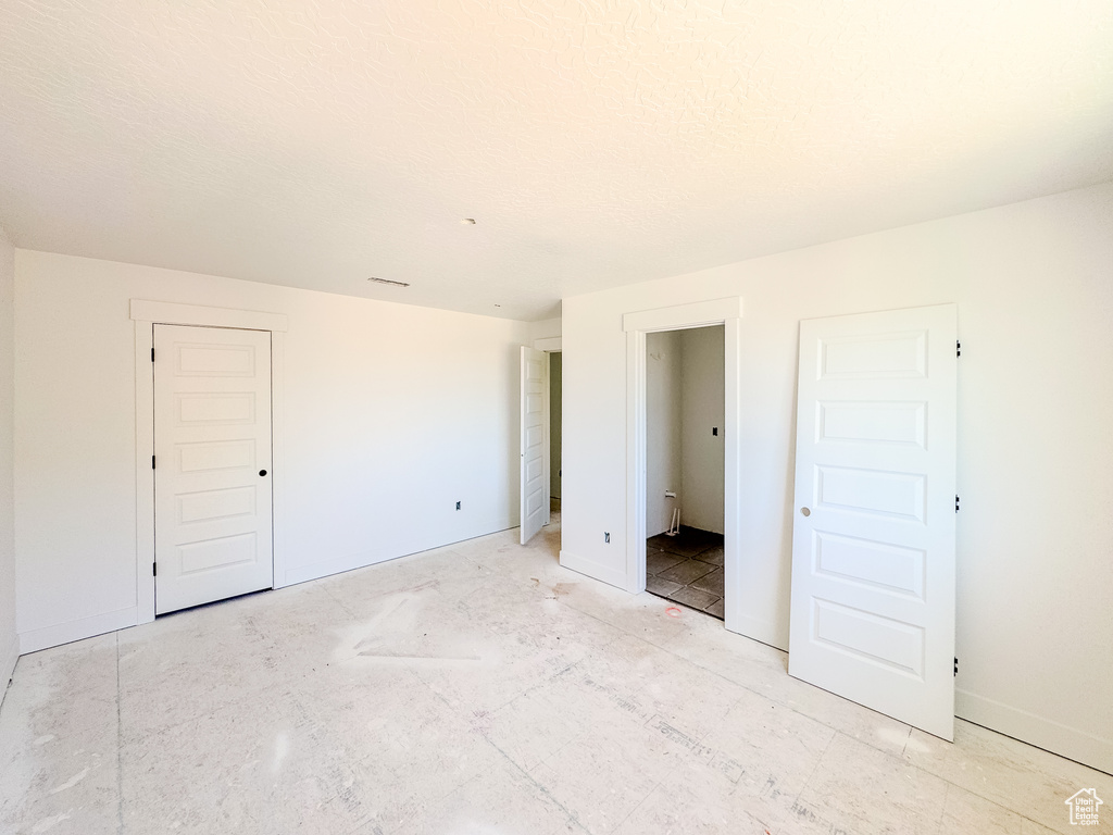 Unfurnished bedroom with baseboards